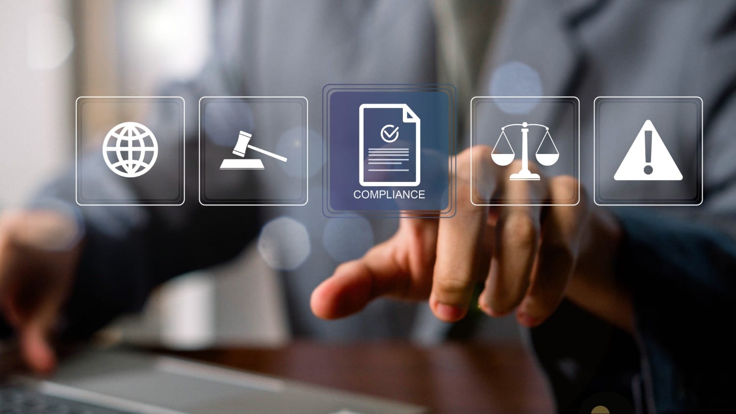 A person touching a compliance icon on a virtual screen with law and safety symbols.